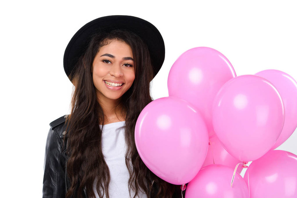 happy young woman in leather jacket with balloons isolated on white - Foto, immagini
