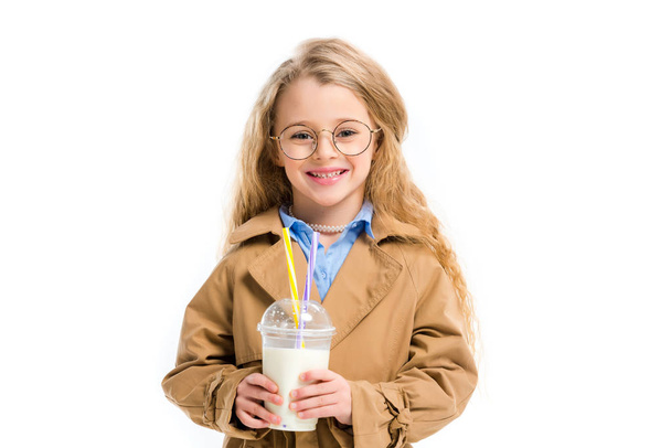 Little smiling kid in glasses holding milkshake isolated on white - Фото, изображение