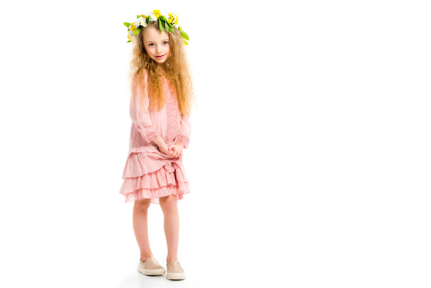 Child in pink dress wearing wreath band from flowers isolated on white - Photo, Image