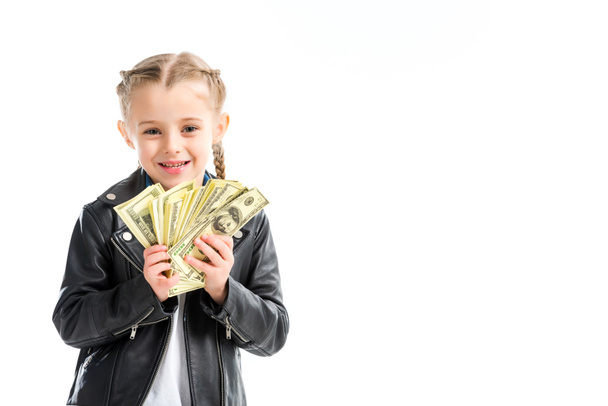 Portrait of excited child in leather jacket holding banknotes isolated on white - Foto, immagini