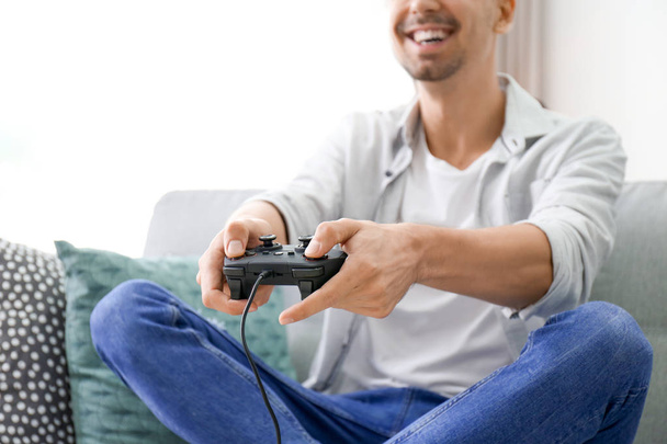 Young man playing video games at home, closeup - Foto, afbeelding