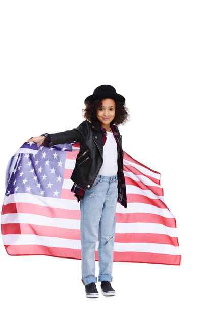 beautiful little child in stylish hat and leather jacket with usa flag isolated on white - Фото, изображение