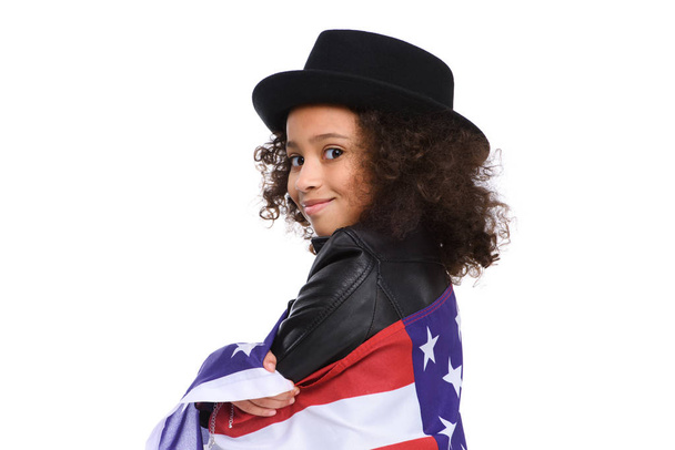 close-up portrait of smiling little child in hat covered in usa flag isolated on white - Photo, Image