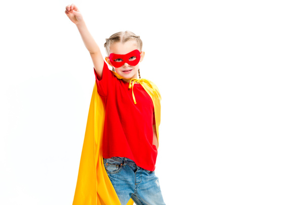 Supergirl wearing yellow cape and red mask for eyes gesturing by hand isolated on white - Foto, imagen