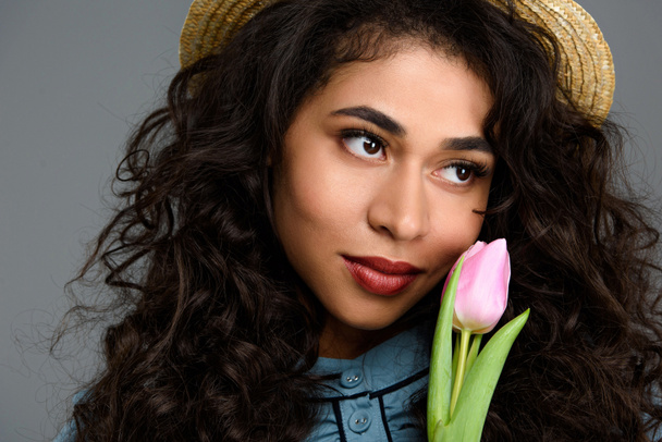 close-up portrait of beautiful young woman with tulip flower isolated on grey - Fotografie, Obrázek