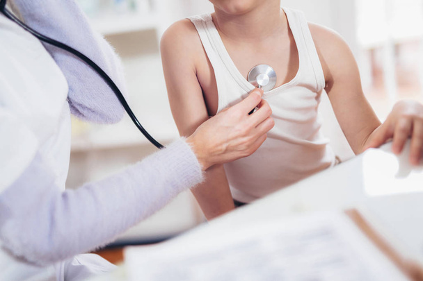 Doctor examining little boyl by stethoscope - Photo, Image