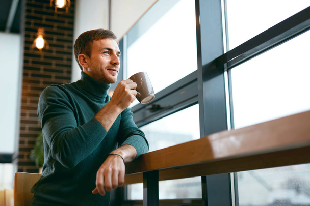 Man Drinking Coffee Drink In Cafe Near Window - Фото, зображення