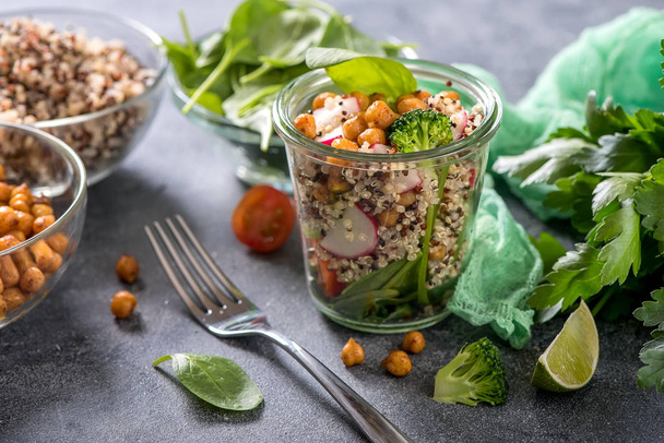 Quinoa salad with chickpeas, spinach, avocado and veggies, healt - Photo, Image