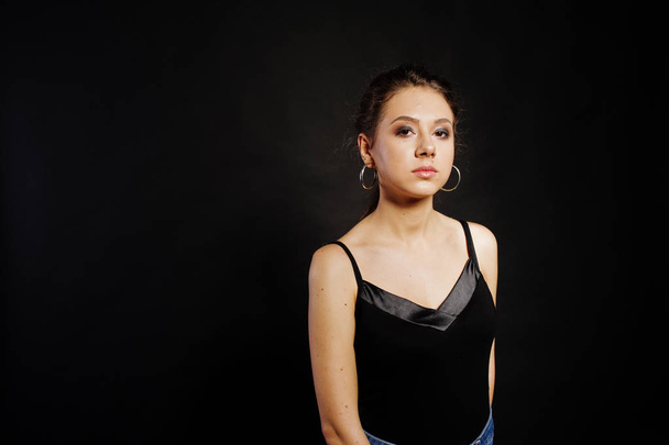 Studio portrait of brunette girl with make up on black backgroun - Valokuva, kuva