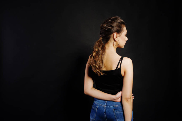 Studio portrait of back hairdress brunette girl  on black backgr - Foto, Imagem