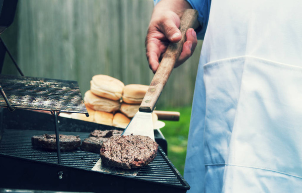 a senior male grilling food.  - Photo, image