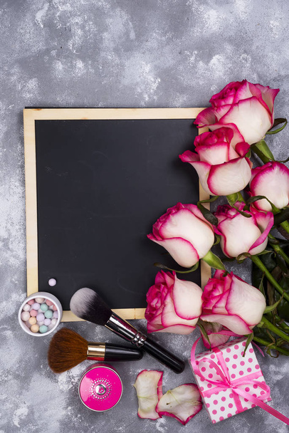 Roses and decorative cosmetics with a chalkboard - Photo, Image