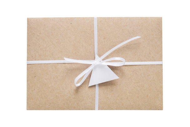 Envelope from craft paper decorated with ribbon and label. Isolated on white. - Foto, Imagen