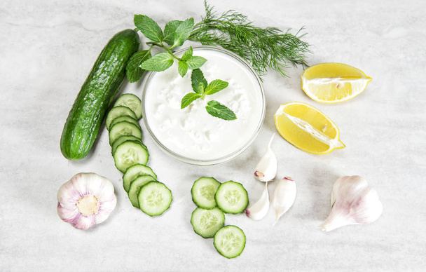 Tzatziki sauce ingredients Yoghurt herbs vegetables food - Фото, зображення