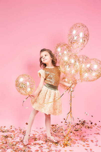 Happy young girl holding bunch of balloons - Photo, Image