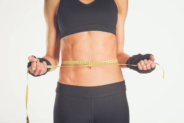 Fitness womans beautiful body with measure tape - Fotoğraf, Görsel