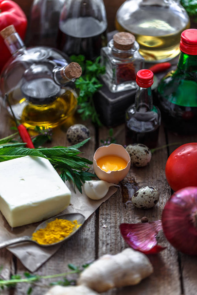 Various ingredients for cooking: oils, sauces, spices and vegetables - Photo, image