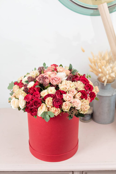 Beautiful luxury bouquet of mixed flowers in red box. the work of the florist at a flower shop. Wallpaper - Fotoğraf, Görsel