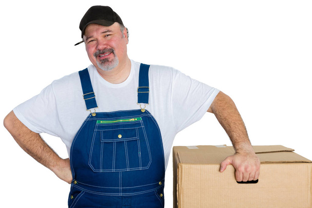 Smiling delivery man standing by big box - Zdjęcie, obraz