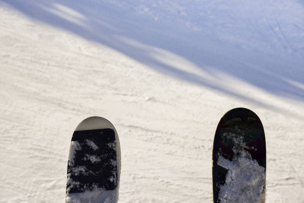 Pair of skis captured at a chairlift looking down onto piste  - Photo, Image