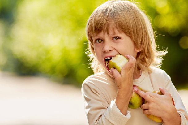 boy biting apple - Foto, afbeelding
