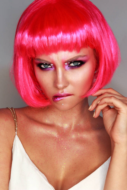 Girl in a bright pink wig with bright makeup - Photo, image