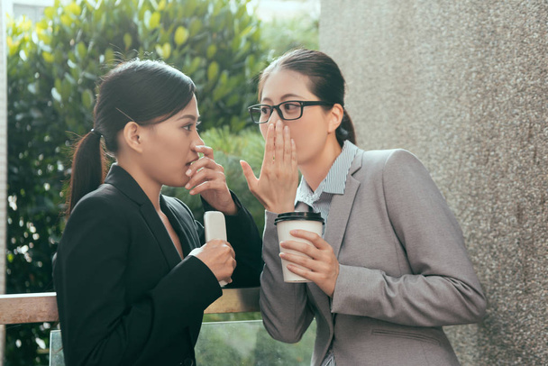 Asian women talking about office gossip - Foto, imagen