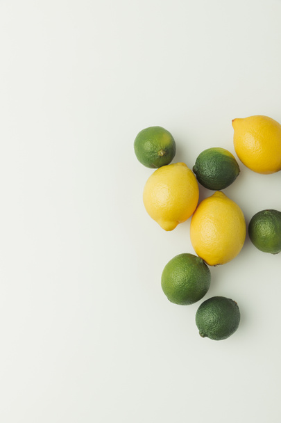 Green limes and yellow lemons isolated on white background - Foto, Bild