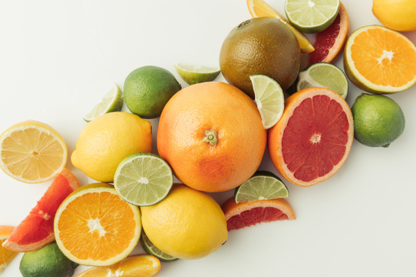 Pile of citruses whole and pieces isolated on white background - Foto, Imagem