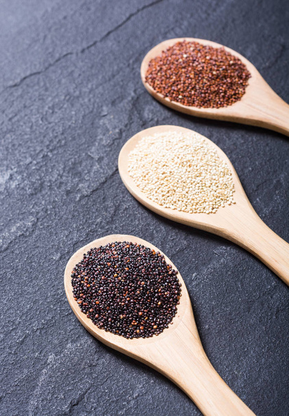 Black , white and red quinoa in spoon  - Photo, image