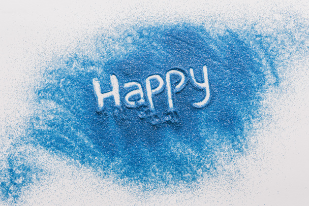 top view of happy sign made of blue sand on white surface - Fotoğraf, Görsel