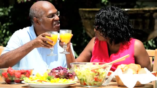 Retired diverse couple healthy drinking and eating salad - Footage, Video