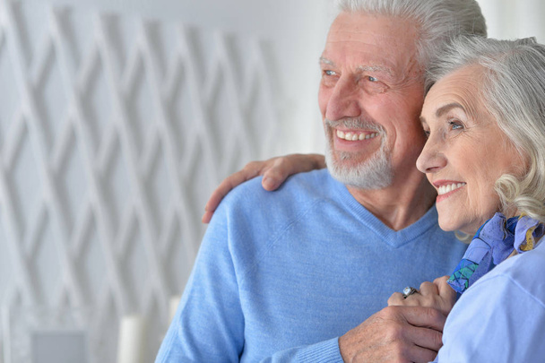 portrait of a happy senior couple hugging  at home - Fotoğraf, Görsel