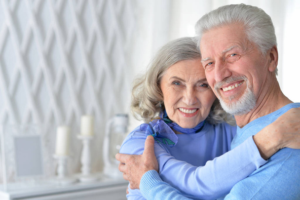 portrait of a happy senior couple hugging  at home - Photo, image