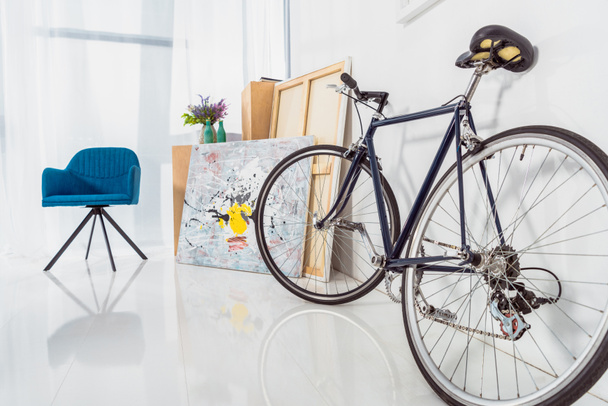 Bicycle and blue chair in stylish light room  - Foto, imagen