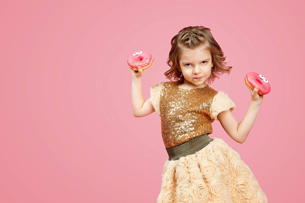 Little girl in dress with donuts - 写真・画像