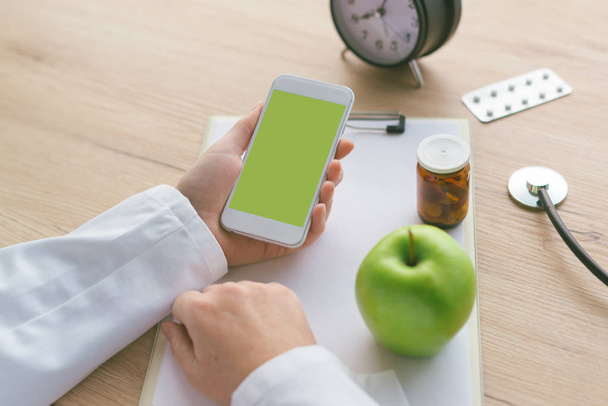 Doctor advising apple instead of pills and antibiotics - Fotografie, Obrázek