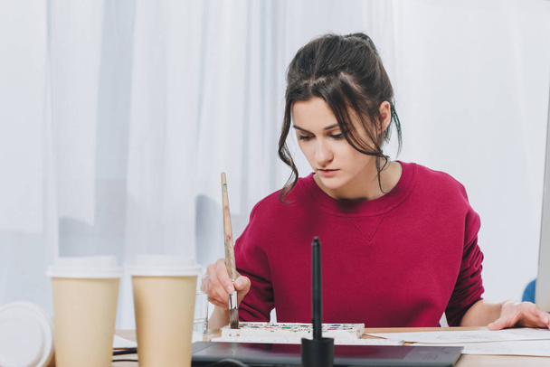 Attractive young girl working on illustrations in home office - Photo, Image
