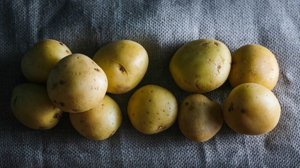 young, potato dark bacround moody food  - Foto, Imagen
