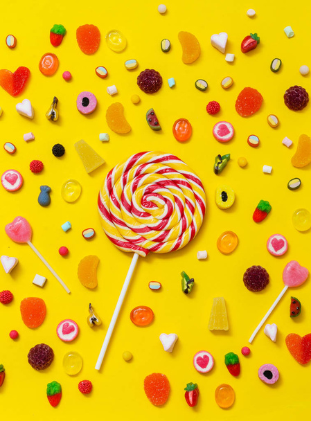 colorful candies  on the yellow background - Zdjęcie, obraz