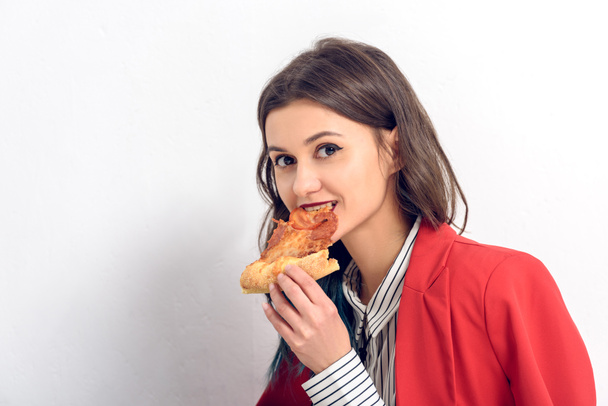 Young woman eating pizza on white background - Photo, Image