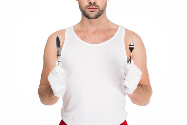 Cropped view of man holding fork and knife isolated on white, easter concept - Photo, Image