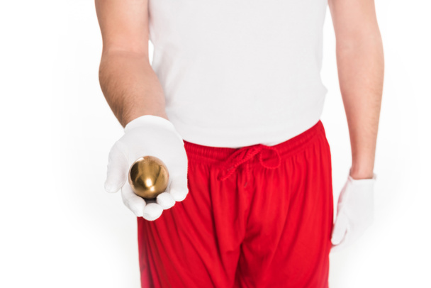 Частковий вигляд людини, що тримає золоте яйце в руці ізольовано на білому, Великодньому концепті
 - Фото, зображення