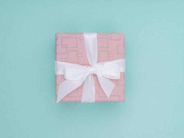 Wrapped gift box. Pastel Colour flat lay minimal concept. - Фото, зображення