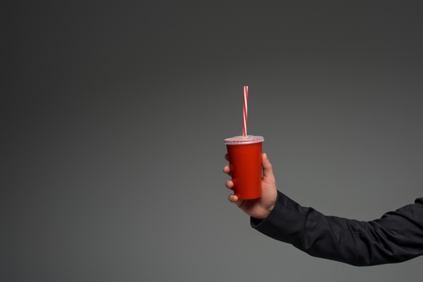 View of disposable cup in male hand isolated on grey - Fotografie, Obrázek