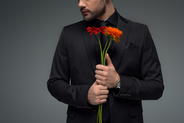 Cropped view of male with bouquet of flowers isolated on grey, international womens day concept - Fotografie, Obrázek