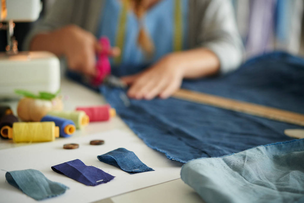 Samples of blue fabric on table of working tailor, selective focus - Photo, Image