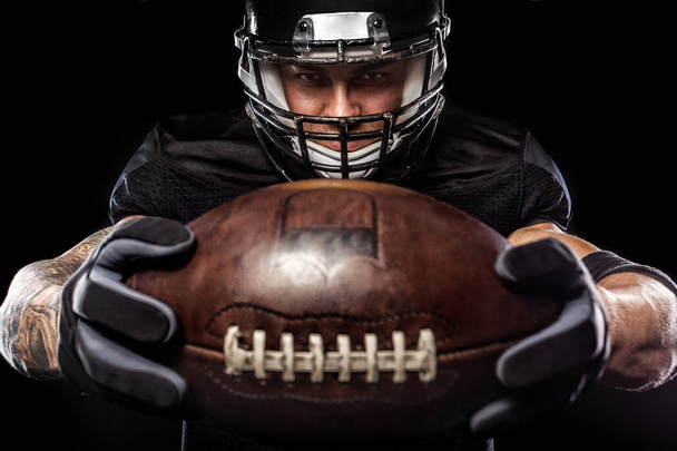 American football sportsman player isolated on black background - Foto, Imagen