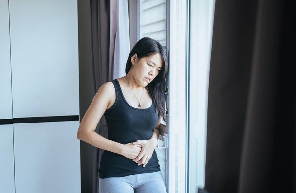Woman having painful stomachache,Female suffering from abdominal pain after wake up - Valokuva, kuva