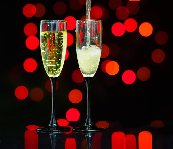 Glasses of champagne on bright background with bokeh effect. Cheers - Fotoğraf, Görsel